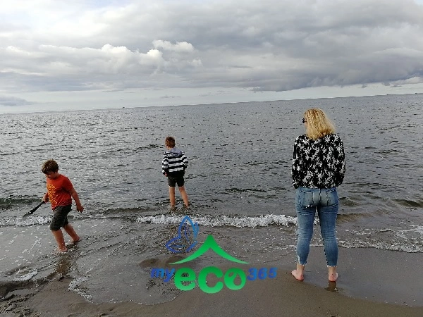kobieta z dziećmi na brzegu morza